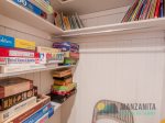 Downstairs is a closet with games, a game table, puzzles, and kids books.